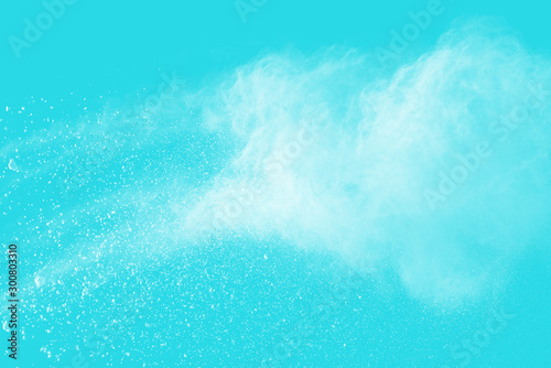 Explosion of colored powder isolated on blue background. Abstract colored background. holi festival.