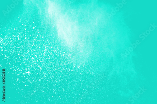 Explosion of colored powder isolated on blue background. Abstract colored background. holi festival.