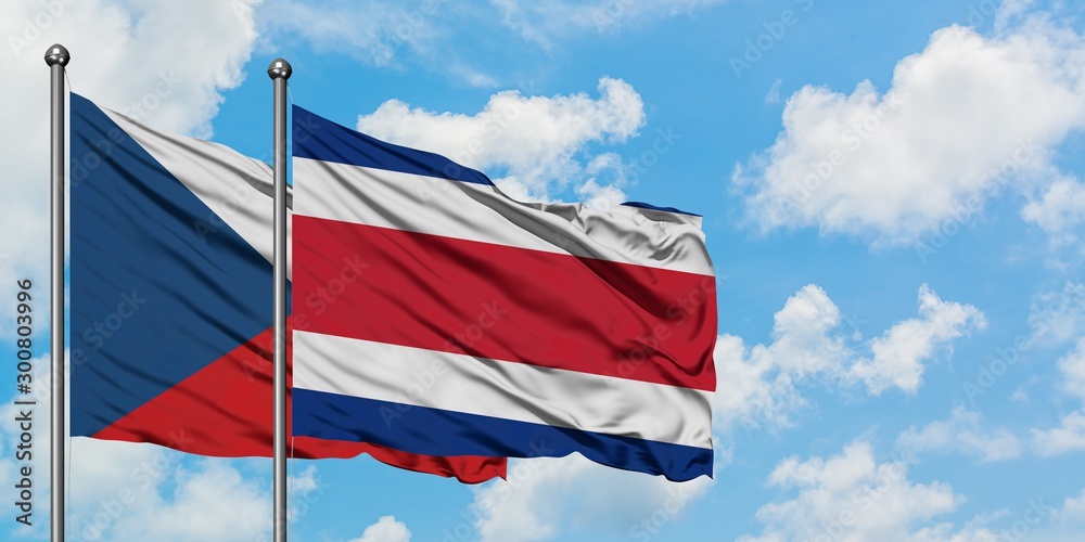Czech Republic and Costa Rica flag waving in the wind against white cloudy blue sky together. Diplomacy concept, international relations.