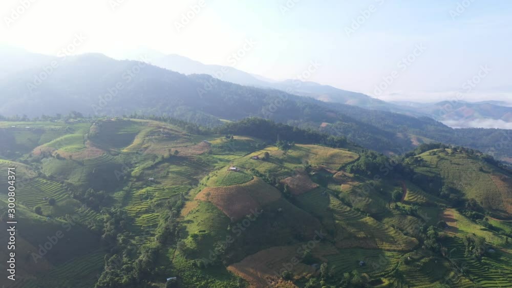 Aerial view morning scene of Pa Bong Piang paddy terraced rice fields with farm huts, Mae Chaem, Chiang Mai Thailand Aerial view morning scene of Pa Bong Piang paddy terraced rice fields with farm huts, Mae Chaem, Chiang Mai Thailand