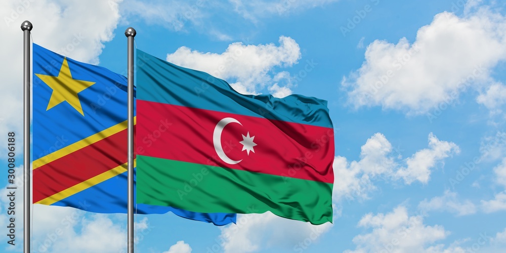 Congo and Azerbaijan flag waving in the wind against white cloudy blue sky together. Diplomacy concept, international relations. Congo and Azerbaijan flag waving in the wind against white cloudy blue sky together. Diplomacy concept, international relations.