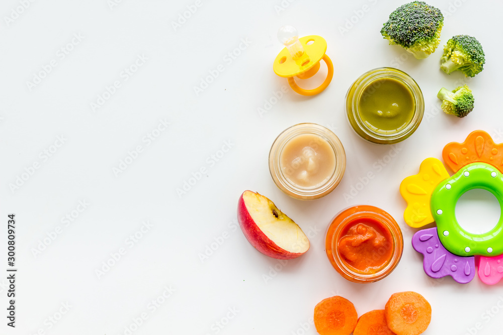 Mashed food for small babies. Colorful vegetable puree on white background top view copy space