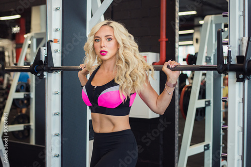 beautiful blonde woman on training with barbell