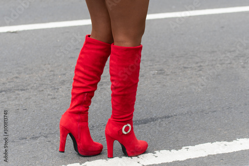 Obraz na płótnie Close up of sexy red high heel boots of woman standing in the street during Panama Parade celebrating Flag Day in Panama, which is November 4th. Copy space. w salonie