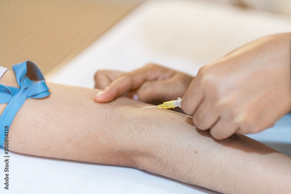 A nurse inserted needle in to the patient for chemotherapy A nurse inserted needle in to the patient for chemotherapy