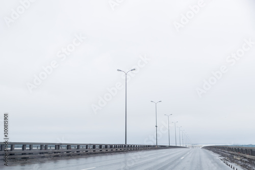 industrial and transport concept of empty free European highway between mountains scenery landscape in cloudy and rainy weather.rainy road without cars,strong wind. Bad weather and harsh conditions of © Yulia