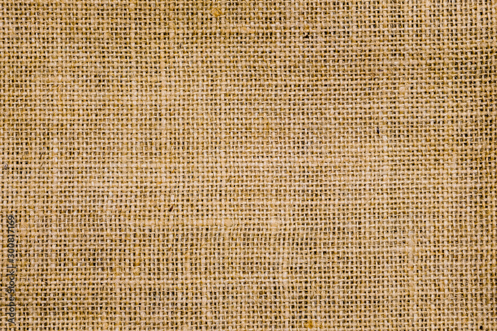 Rough hessian background with flecks of varying colors of beige and brown. with copy space. office desk concept, Hessian sackcloth burlap woven texture background. Rough hessian background with flecks of varying colors of beige and brown. with copy space. office desk concept, Hessian sackcloth burlap woven texture background.