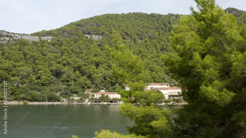 little vacation village hide behinde Trees laying in Lagoon at Mljet Island in Croatia (aerial) little vacation village hide behinde Trees laying in Lagoon at Mljet Island in Croatia (aerial)