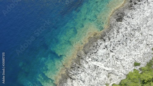 deep blue and colorful turquoise Sea with beach of Trees on Island (aerial) photo