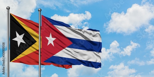 East Timor and Cuba flag waving in the wind against white cloudy blue sky together. Diplomacy concept, international relations.