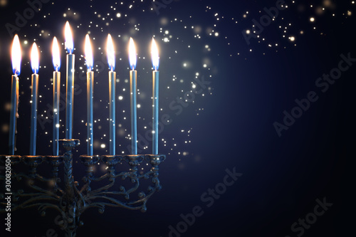 Religion image of jewish holiday Hanukkah background with menorah (traditional candelabra) and candles photo
