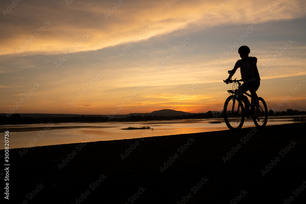 Fototapeta premium Asian men cycling bicycle on the road in the sunset time