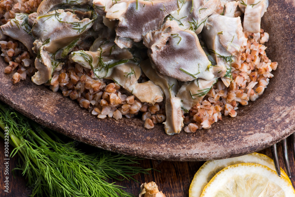 Stewed turkey stomachs with vegetables and buckwheat in a bowl Stewed turkey stomachs with vegetables and buckwheat in a bowl