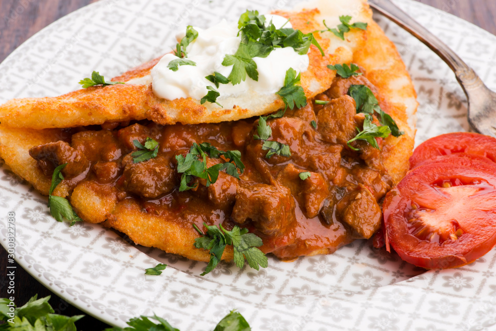 Potato pancakes with meat, vegetable, tomato and parsley Potato pancakes with meat, vegetable, tomato and parsley