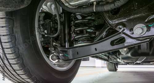 Technical photo. The structure of the modern car. Rear suspension. Shock absorber. Spring suspension.