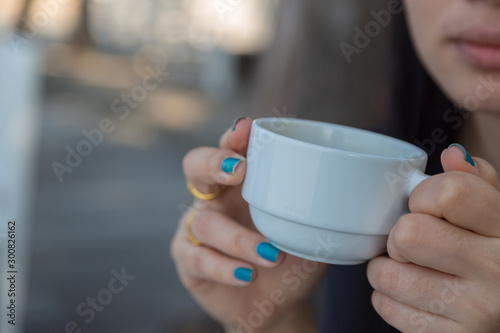 Woman drinking coffee in hand