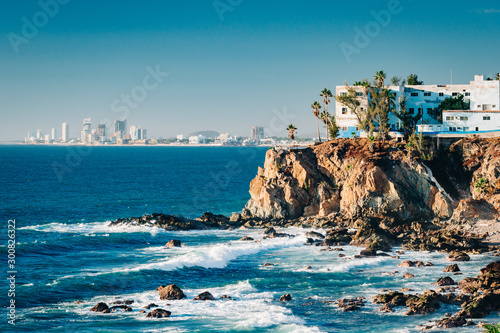 Mazatlan as seen from afar with a spectacular cliff line in the foreground photo