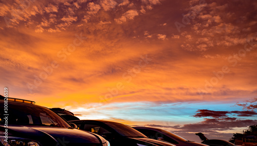 Car parked at outdoor car parking lot of campsite with beautiful sunset sky. Car drive for adventure road trip. Nature landscape. Road trip for summer vacation travel with friends at holidays park.