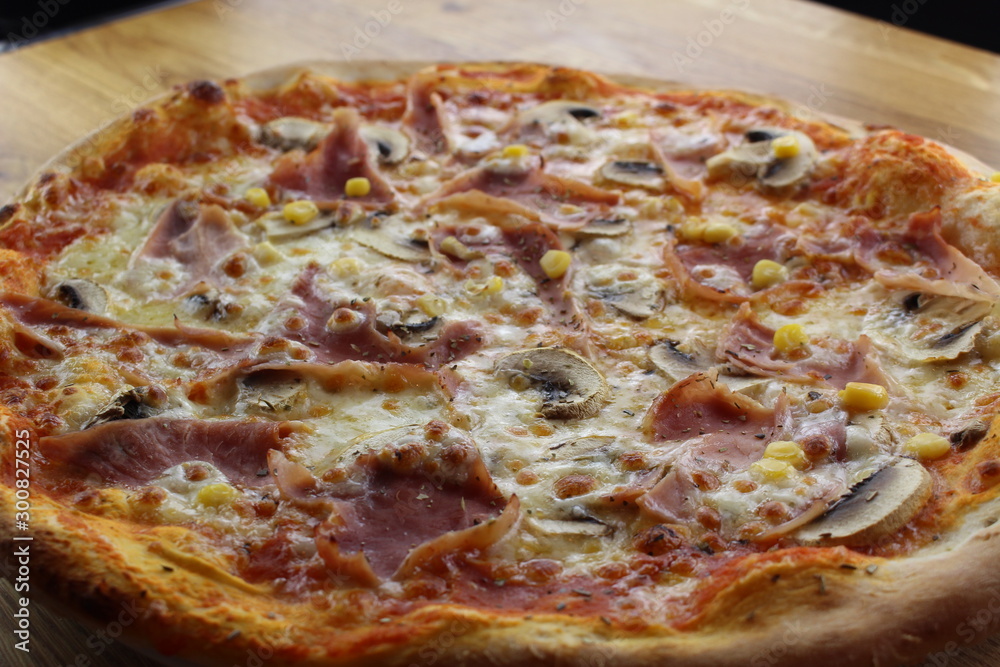 Calabrian pizza with ham, mushroom and cheese on a white plate. Calabrian pizza with ham, mushroom and cheese on a white plate.