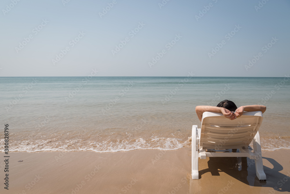 Vacation on tropical beach Woman rest on the beach bed