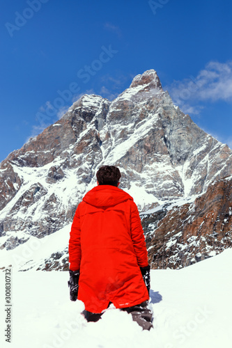 Back view of a skier looking view of the snow white mountain landscape around. Freedom, lifestyle content.