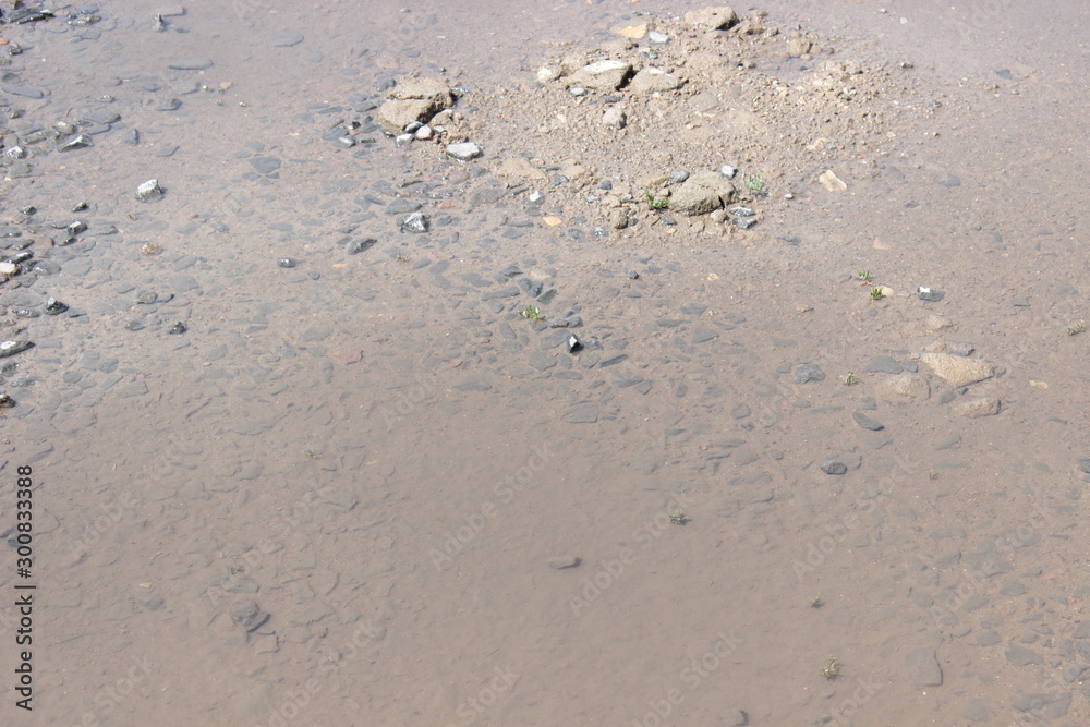 Puddle summer sunny day, rubble muddy water Puddle summer sunny day, rubble muddy water