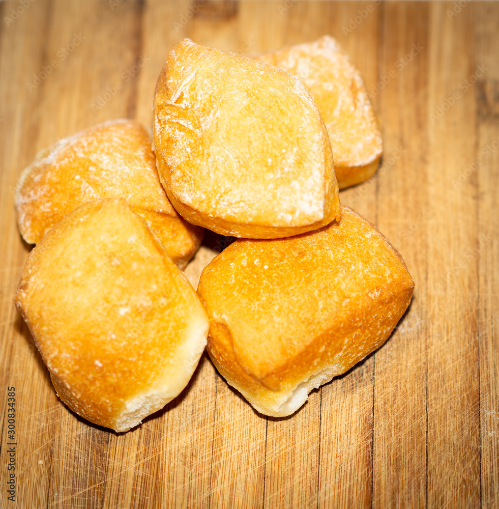 Bread rolls on a wooden cutting board