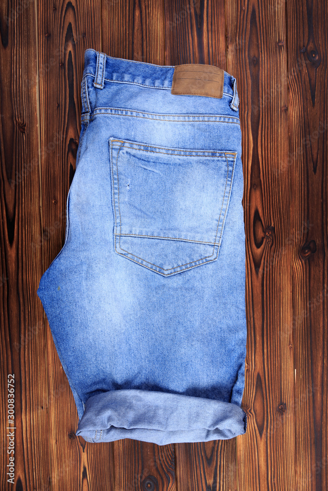 blue denim jeans on wooden background . blue denim jeans on wooden background .