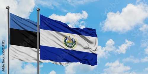 Estonia and El Salvador flag waving in the wind against white cloudy blue sky together. Diplomacy concept, international relations.