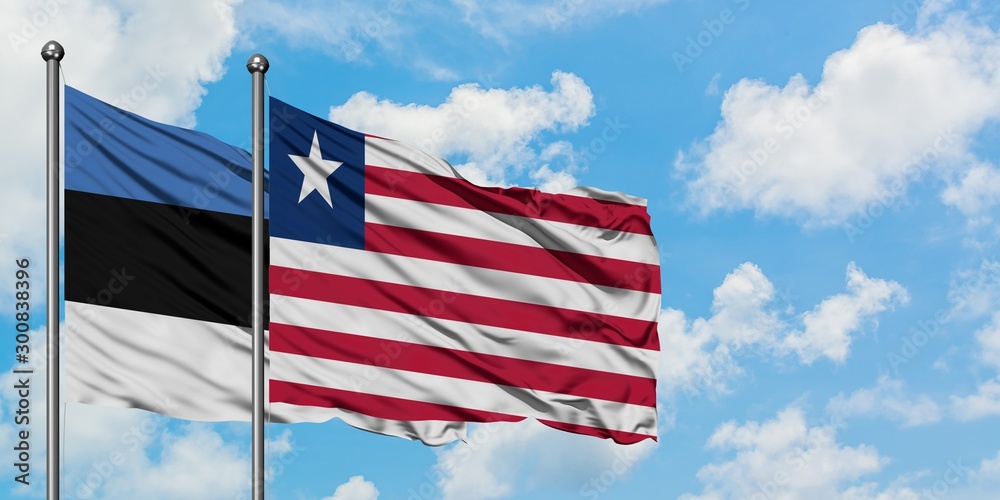 Estonia and Liberia flag waving in the wind against white cloudy blue sky together. Diplomacy concept, international relations. Estonia and Liberia flag waving in the wind against white cloudy blue sky together. Diplomacy concept, international relations.
