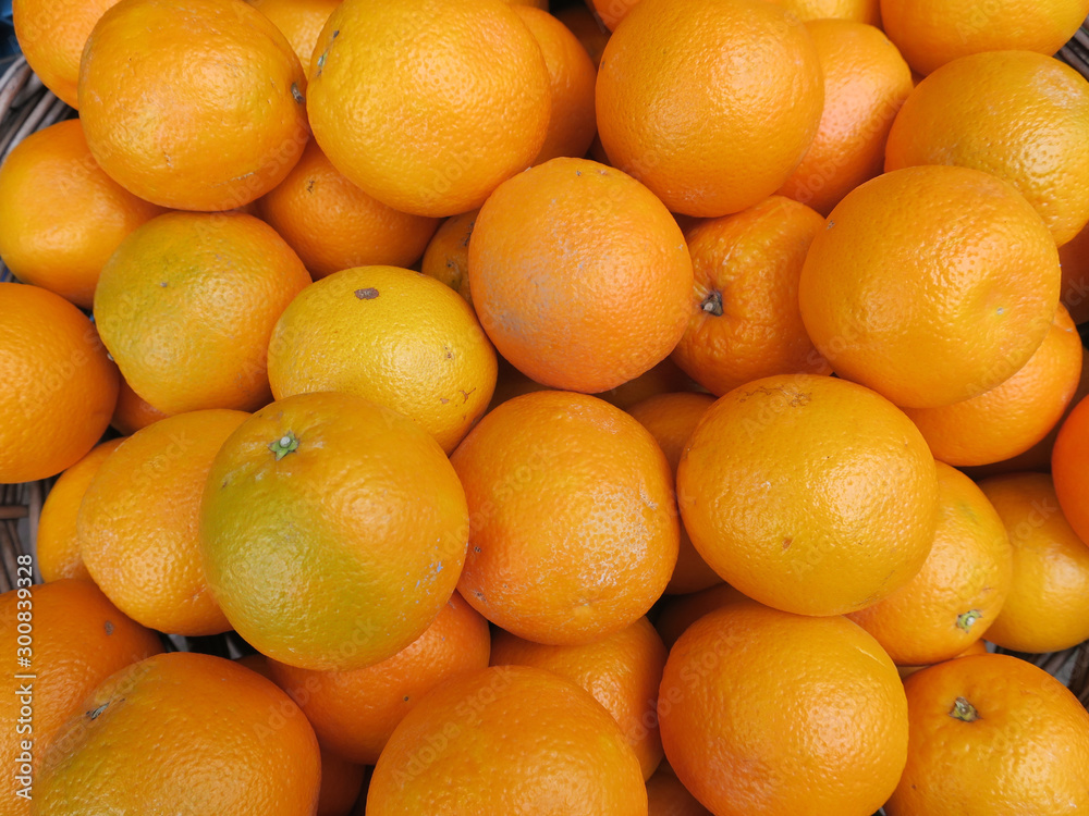 heap of oranges in a reed basket at the grocery heap of oranges in a reed basket at the grocery