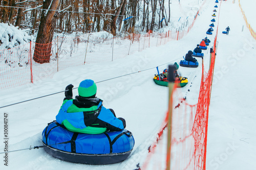 line for snow tubing. pull people up to hill. photo