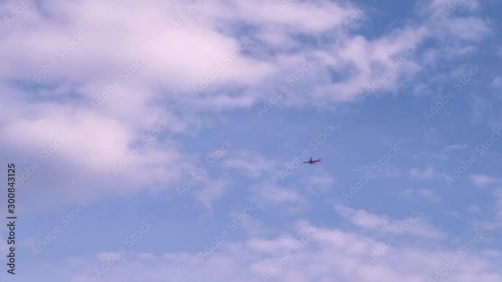 A plane flies through there are frames high in the sky against a background of clouds. A plane flies through there are frames high in the sky against a background of clouds.