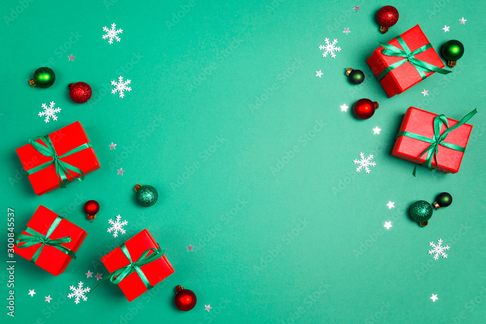 Christmas gifts with decorations and copy space on a green background.