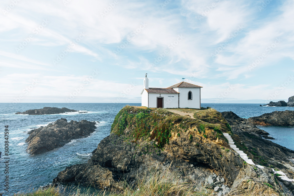 church on the rocks of a cliff by the ocean