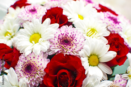 Beautiful red roses and delicate chrysanthemums in mint hat box. The original design of the bouquet.