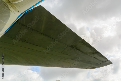 Airplane wing and stabilizer on a cloud background. Background for articles about aviation, travel or business trips.