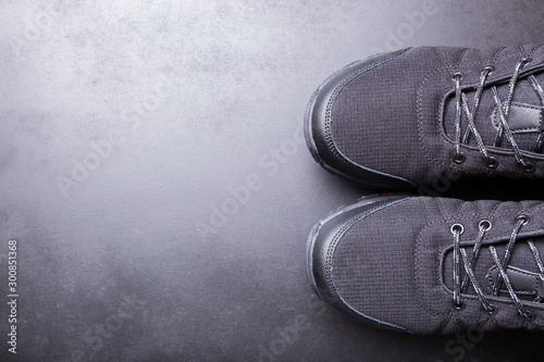 Black men's sneakers close-up on a black isolated background.