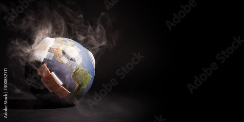 Fototapeta Naklejka Na Ścianę i Meble -  White smoke cover around the globe (World) full of bandages, demonstrating impact of global warming, climate change, pollution from Fossil Fuels Burning, Deforestation, Industrial Revolution.