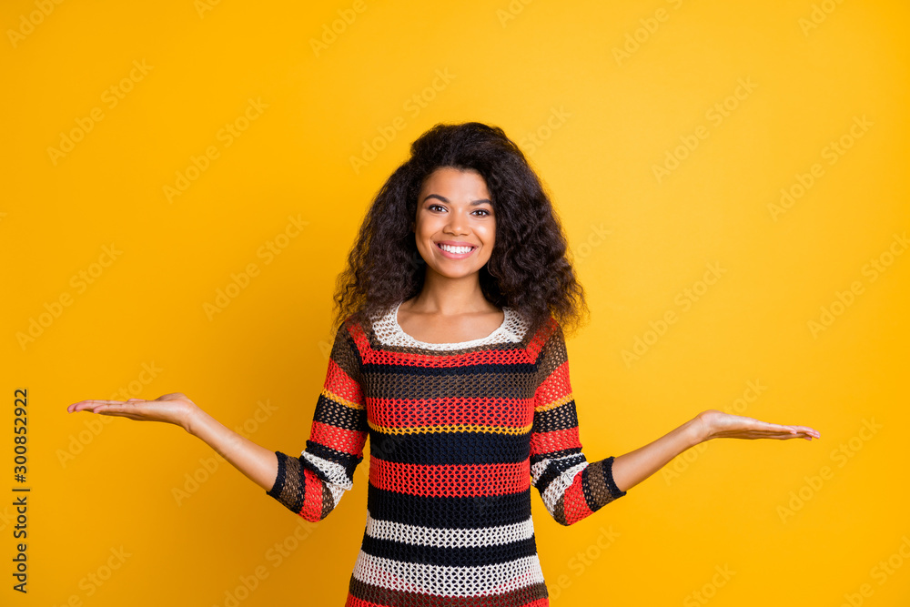 Portrait of her she nice-looking attractive charming cheerful cheery wavy-haired girl wearing knitted sweater weighing invisible objects isolated on bright vivid shine vibrant yellow color background Portrait of her she nice-looking attractive charming cheerful cheery wavy-haired girl wearing knitted sweater weighing invisible objects isolated on bright vivid shine vibrant yellow color background