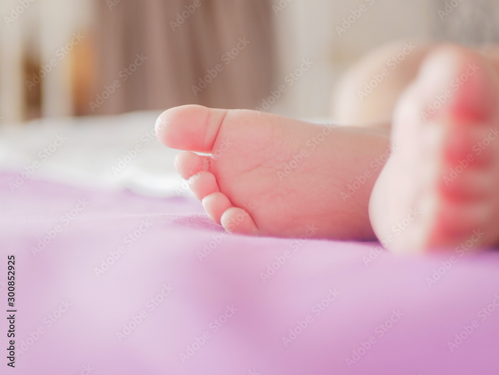 little baby feet. Theres nothing quite so sweet as tiny little baby feet. Little baby boy on bed. Close up. Space for copy.