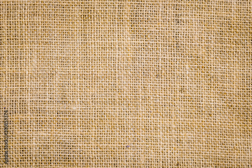 Rough hessian background with flecks of varying colors of beige and brown. with copy space. office desk concept, Hessian sackcloth burlap woven texture background. photo