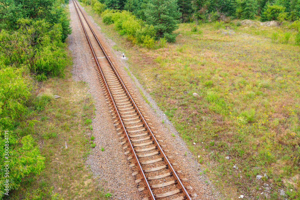 Aerial view of railroad track through a green pine forest Aerial view of railroad track through a green pine forest