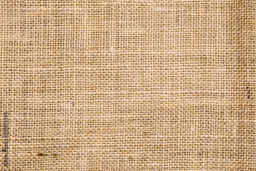 Rough hessian background with flecks of varying colors of beige and brown. with copy space. office desk concept, Hessian sackcloth burlap woven texture background.