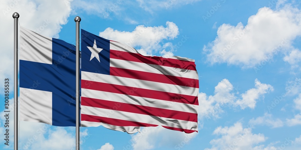 Finland and Liberia flag waving in the wind against white cloudy blue sky together. Diplomacy concept, international relations. Finland and Liberia flag waving in the wind against white cloudy blue sky together. Diplomacy concept, international relations.