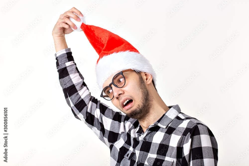 X-mas, winter holidays and people concept - funny man in santa claus hat over white background X-mas, winter holidays and people concept - funny man in santa claus hat over white background