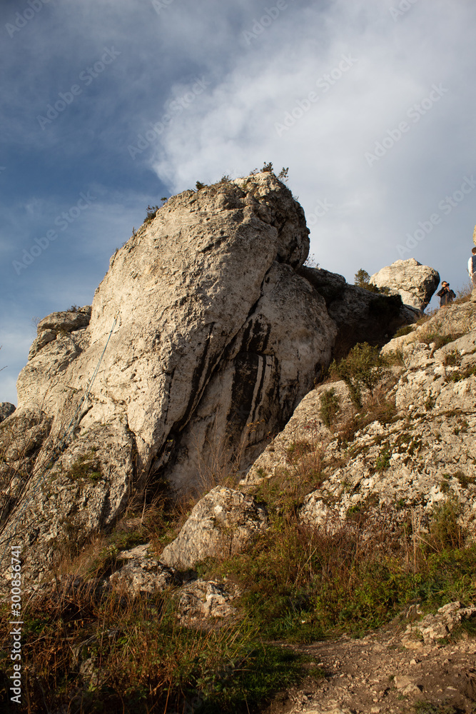 Vertical mountain landscape of limestone cliffs against a blue sky. The Zborow Massif in Central Poland on the Krakow-Czestochowa Upland Vertical mountain landscape of limestone cliffs against a blue sky. The Zborow Massif in Central Poland on the Krakow-Czestochowa Upland