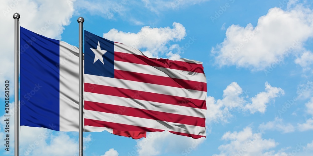 France and Liberia flag waving in the wind against white cloudy blue sky together. Diplomacy concept, international relations. France and Liberia flag waving in the wind against white cloudy blue sky together. Diplomacy concept, international relations.