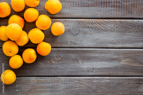 Fruit background with apricots on dark wooden background top view copy space
