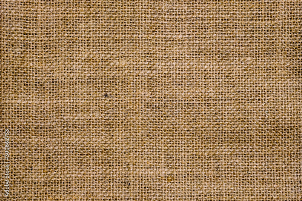 Rough hessian background with flecks of varying colors of beige and brown. with copy space. office desk concept, Hessian sackcloth burlap woven texture background. - obrazy, fototapety, plakaty 